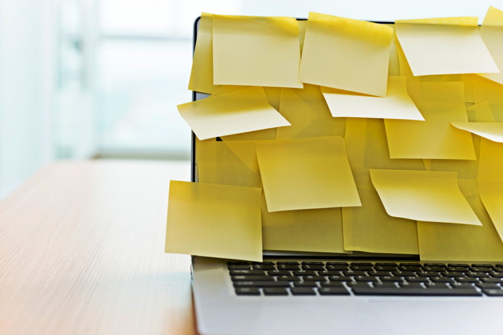 laptop covered with sticky notes