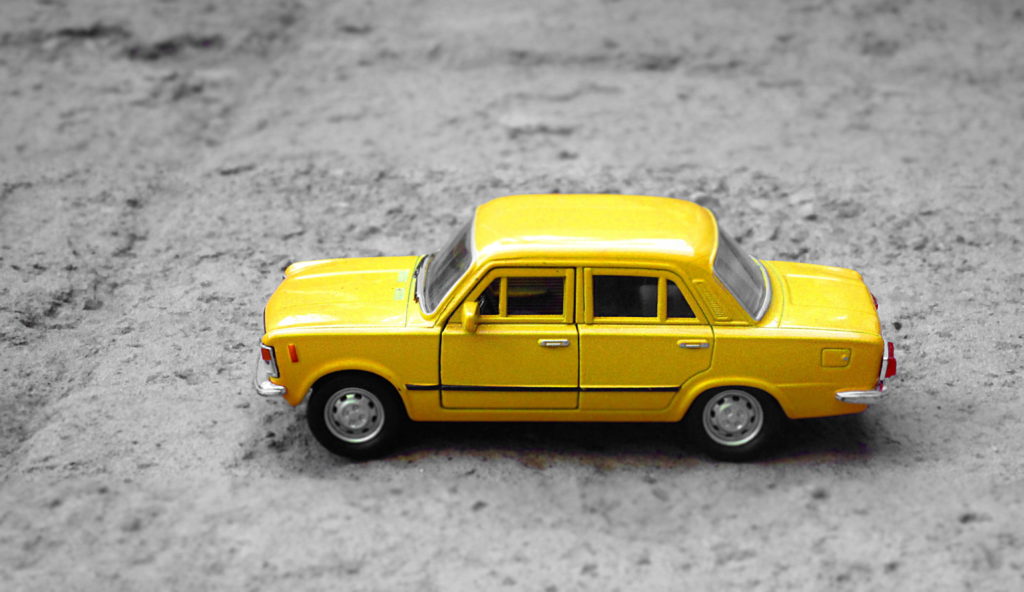 yellow toy car illustrating an autonomous vehicle